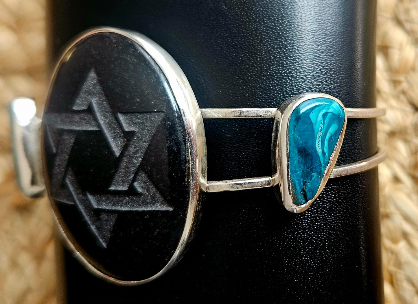 Sterling silver cuff bracelet with a 40x30mm black onyx cab, engraved with a star of David and 2 accent stones of Eilat stone from Israel, side 2 view