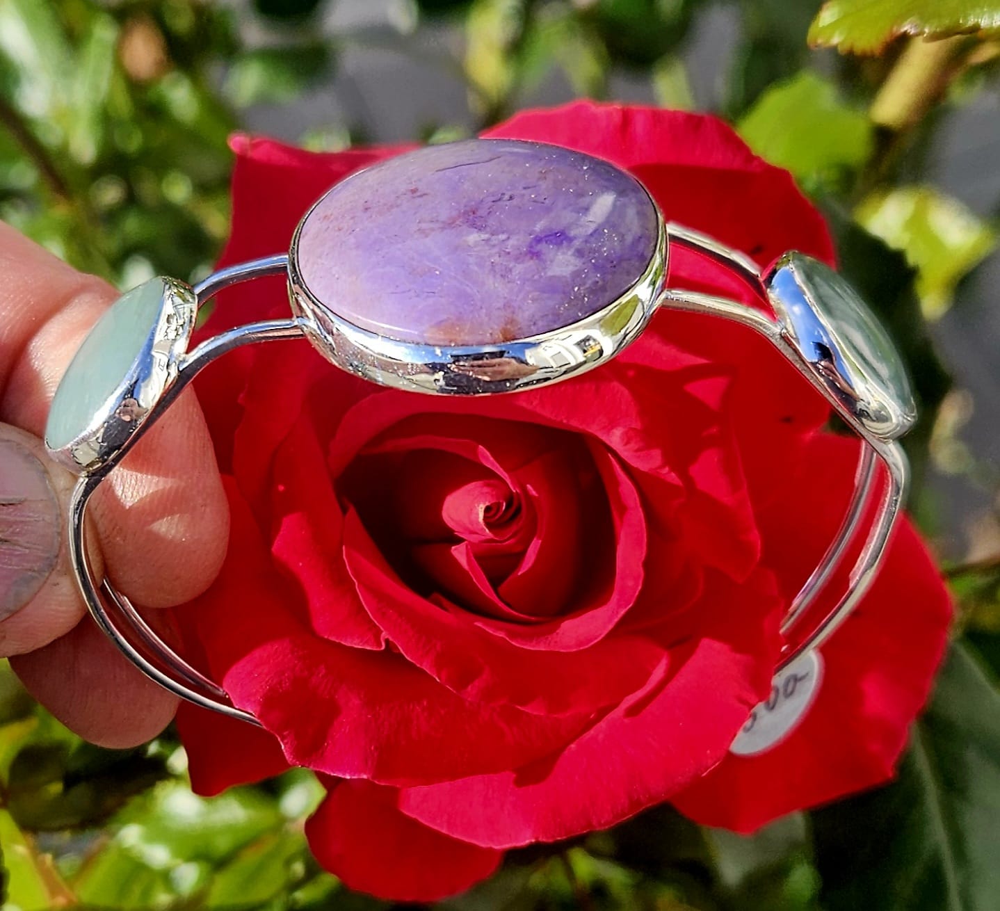 Sterling Silver Cuff bracelet with a 40x30mm cabochon of rare lavender Turkish nephrite jade, flanked by a pair of 18mm round cabochons of pale green Inanga Pounamu (nephrite jade) from New Zealand, all hand cut and set in sterling silver, side view.