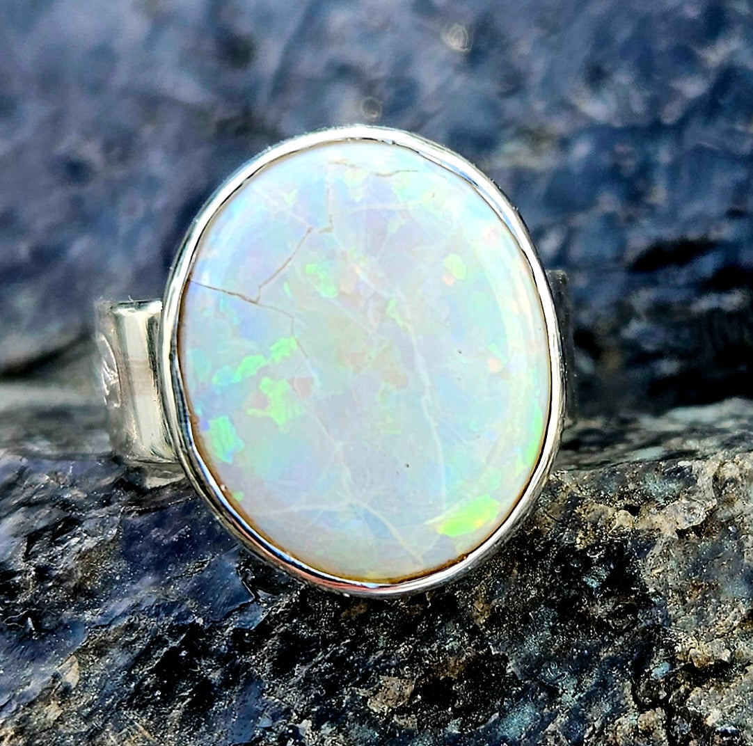 A beautiful 5.6ct Australian opal with lots of fire, hand cut and polished and set in a sterling silver, adjustable ring, front-1.