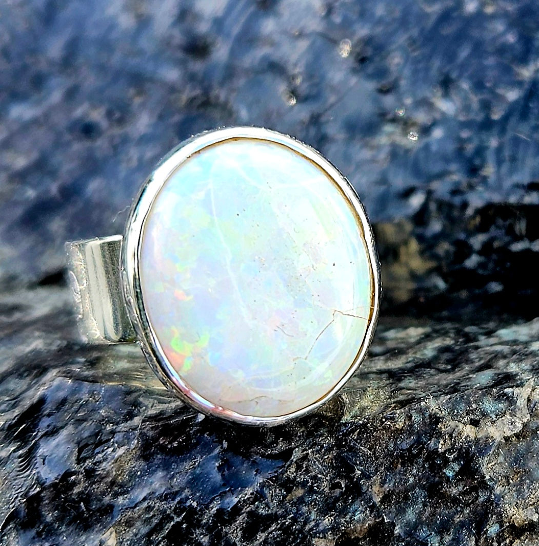 A beautiful 5.6ct Australian opal with lots of fire, hand cut and polished and set in a sterling silver, adjustable ring, front-2.