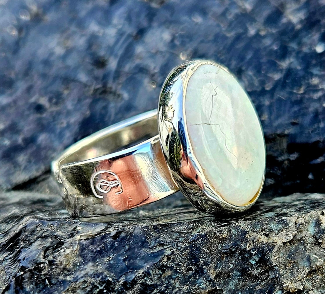 A beautiful 5.6ct Australian opal with lots of fire, hand cut and polished and set in a sterling silver, adjustable ring, Angle.