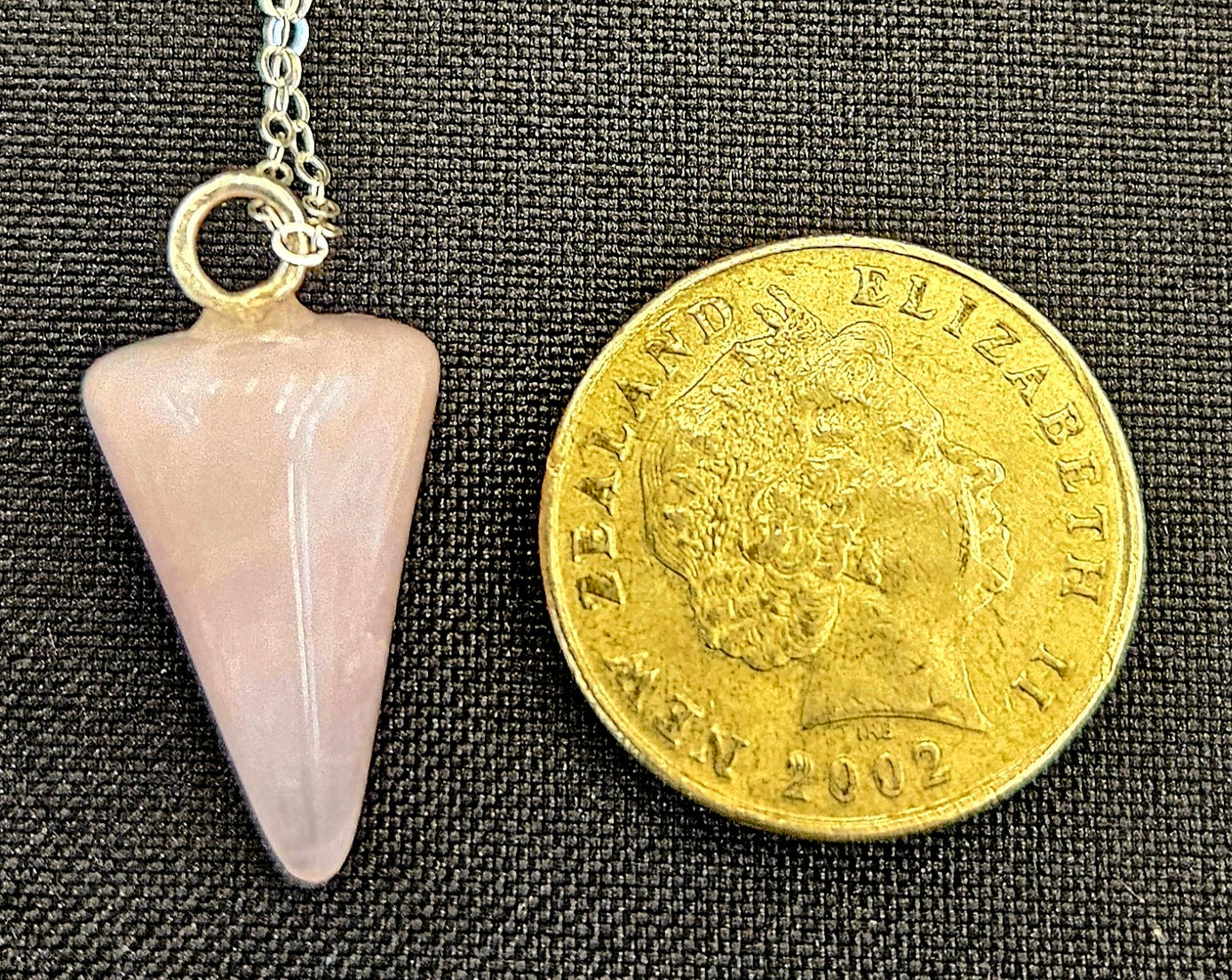 Rose Quartz pendulum set to be worn as a necklace, so it's always handy, with a sterling silver chain with NZ one dollar coin for size comparison.