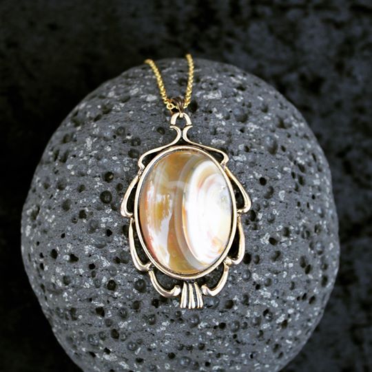 Necklace with a deep purple rhyolite that I collected from the Broken Hills region of the Coromandel Peninsula in New Zealand and hand polished into a 40x30mm cabochon, set in silver plated setting with 19 inch chain - on black scoria