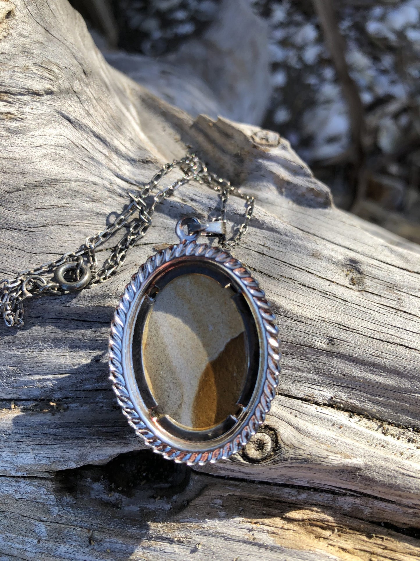 Necklace with Picture Jasper from Oregon, USA with a subtle canyon scene composed of browns, tans and greys. The stone is hand polished to a 25x18mm cabochon and set in a silver-plated setting with 19 inch chain, back