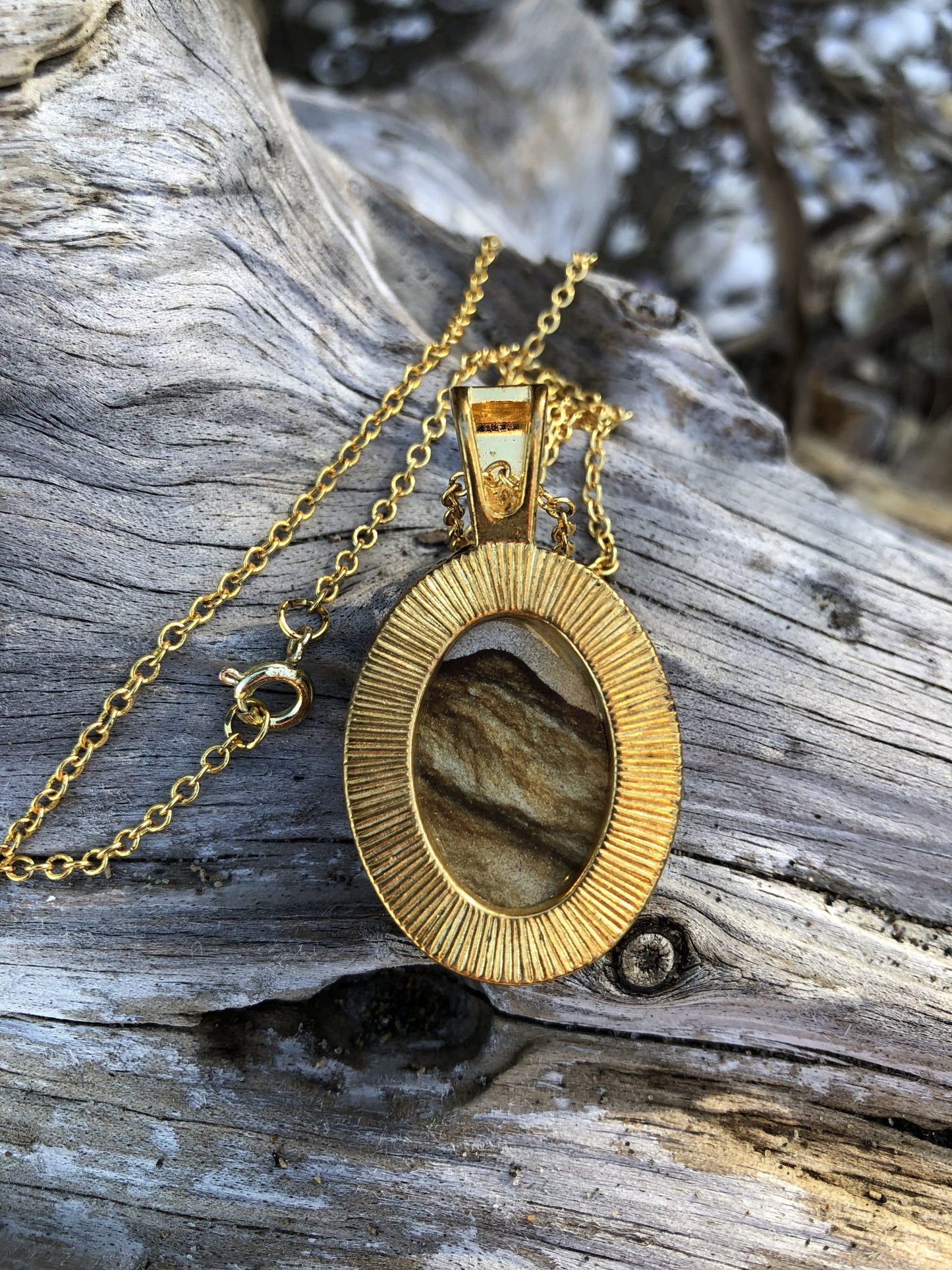 Necklace with Picture Jasper from Oregon, USA with a beautiful mountain scene composed of browns, tans and greys. The stone is hand polished to a 25x18mm cabochon and set in a gold-plated setting with 19 inch chain, back