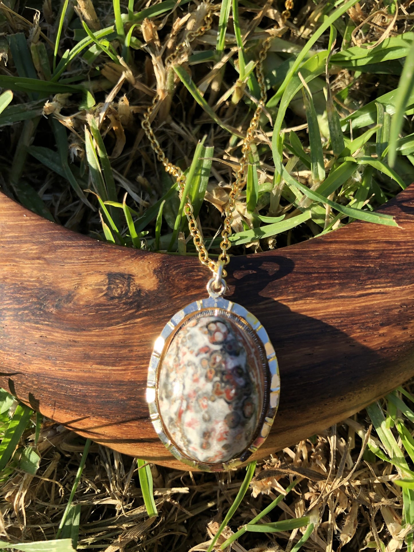 Necklace with Leopard Skin Jasper collected from Brazil, and hand polished into a 25x18mm cabochon, set in a gold-plated setting with 19 inch chain. This stone shows the characteristic pattern of this stone of pink and grey dots, lighter