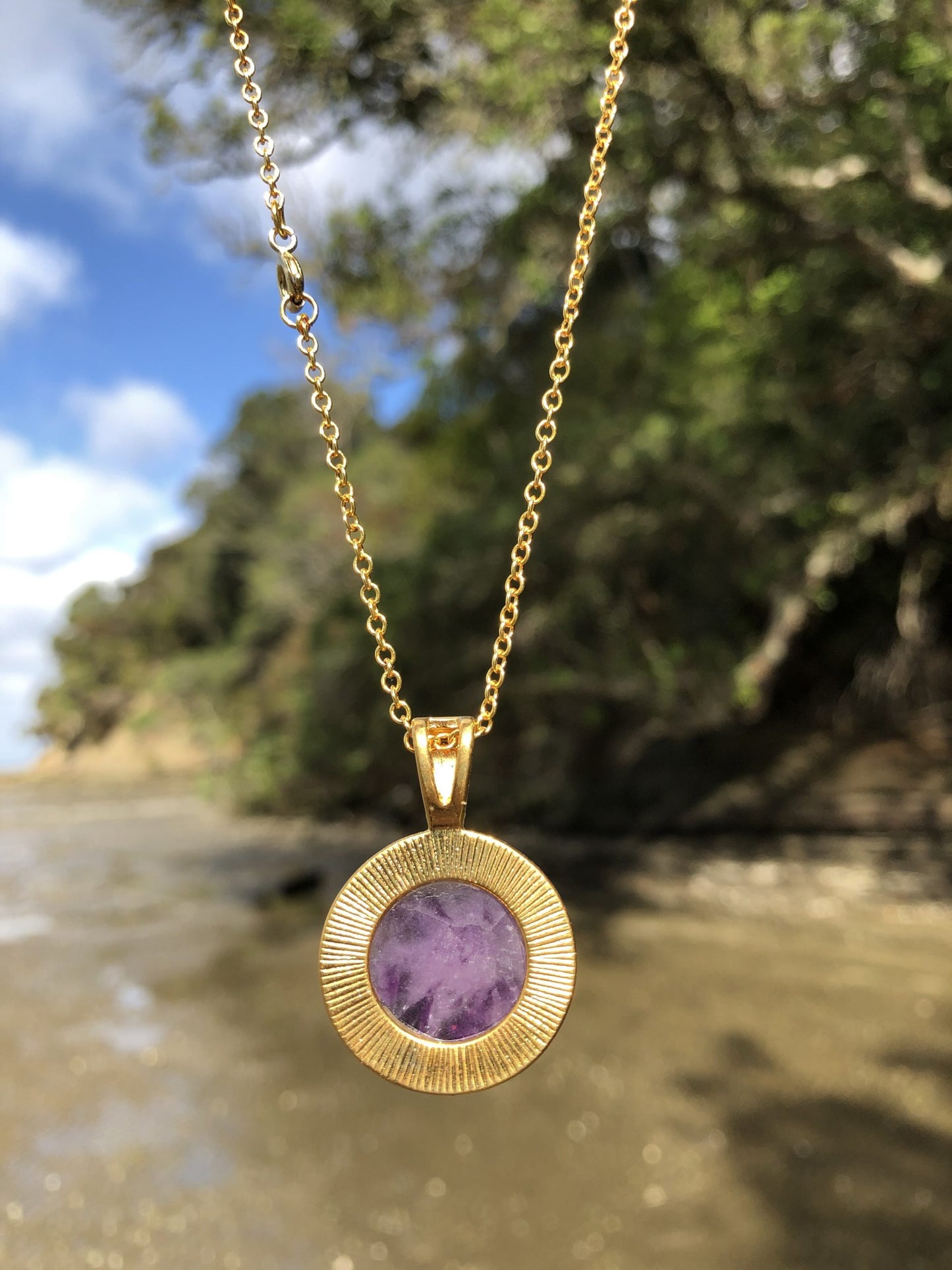 Necklace with beautiful purple Amethyst with natural color variations from crystal growth, hand polished to a 18mm round cabochon and set in a gold-plated setting with 19 inch chain, back