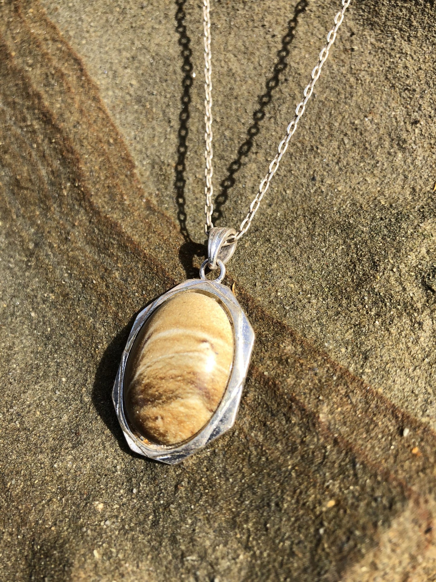 Necklace with a natural Kalahari Desert landscape jasper with a beautiful desert scene, naturally created in tan and brown, hand polished to a 25x18mm cabochon and set in a silver-plated setting with 19 inch chain, side