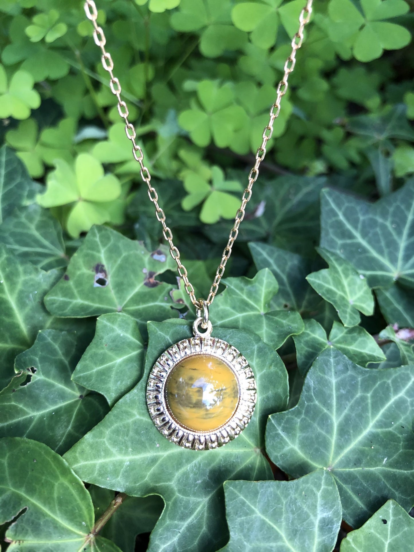 Necklace with Polagonite Jasper collected from Canterbury, South Island New Zealand by a friend of mine and hand polished into a 14mm round cabochon, set in a gold-plated setting with 19 inch chain on ivy