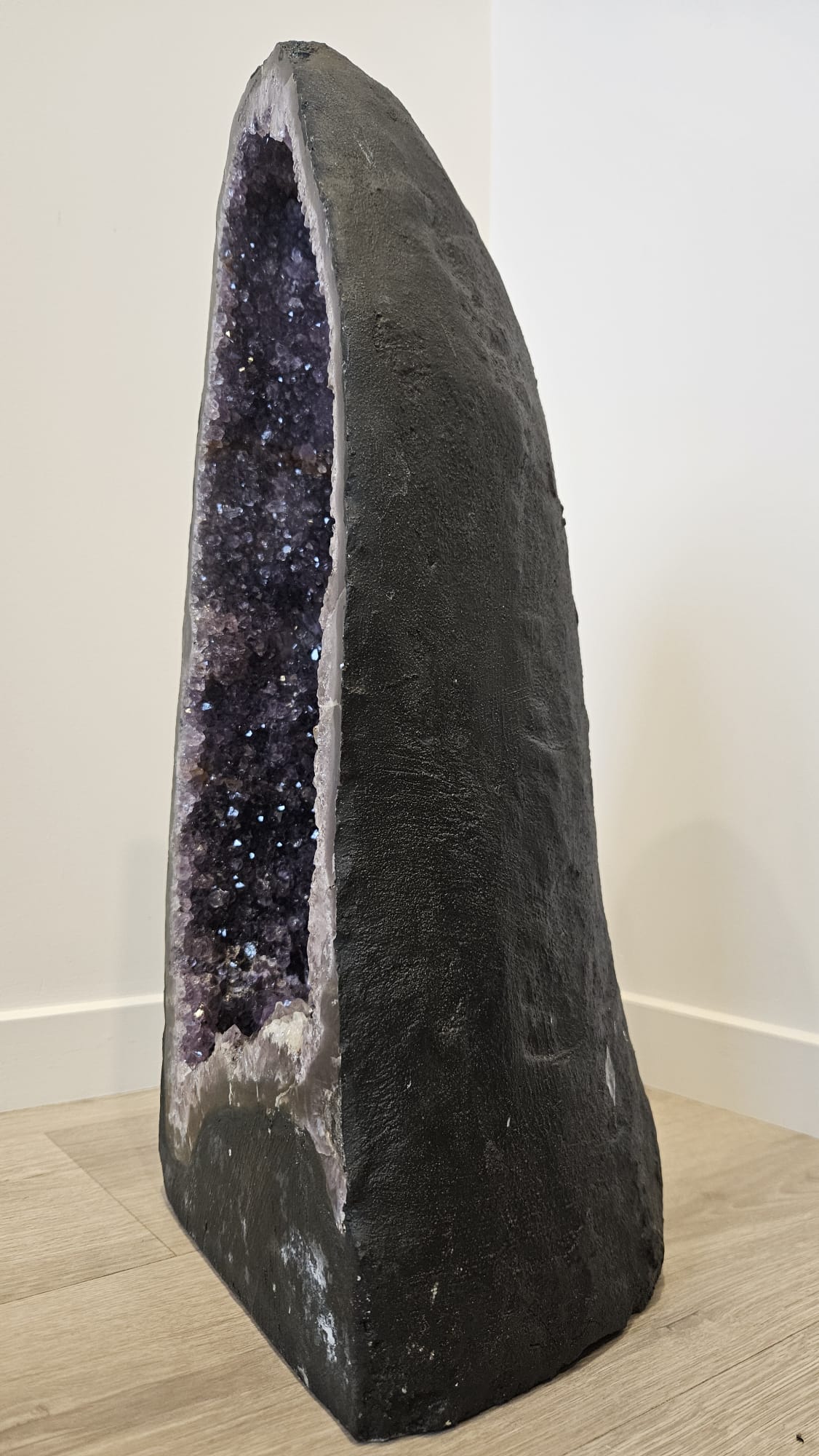 Large amethyst cave with deep purple sparkling crystals, and white calcite crystals at the base. This is 21.5kg, 510mm tall, 245mm wide and 210mm deep, side.