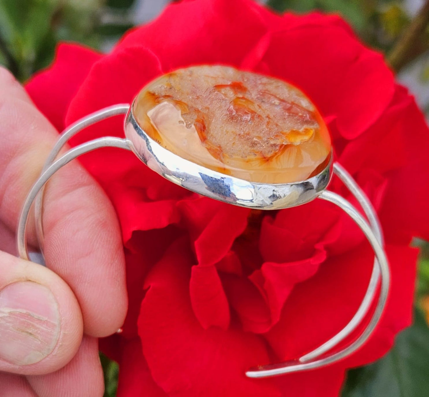 Sterling Silver Cuff bracelet with a unique 52x38mm bright orange carnelian cab, hand cut and polished to preserve the unique natural texture of the stone, side