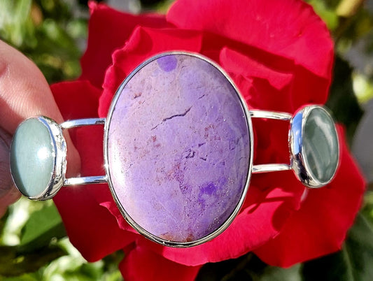 Sterling Silver Cuff bracelet with a 40x30mm cabochon of rare lavender Turkish nephrite jade, flanked by a pair of 18mm round cabochons of pale green Inanga Pounamu (nephrite jade) from New Zealand, all hand cut and set in sterling silver, top view.