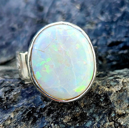 A beautiful 5.6ct Australian opal with lots of fire, hand cut and polished and set in a sterling silver, adjustable ring, front-1.
