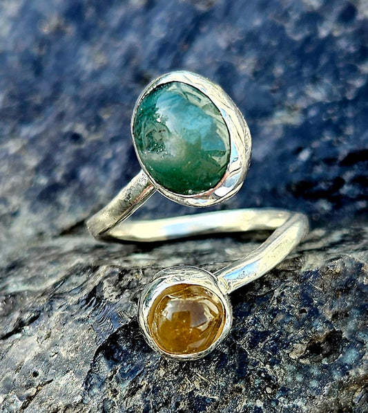 A green mtorolite from Zimbabwe with a yellow citrine from Brazil, hand polished and set in a sterling silver, bypass ring, top.
