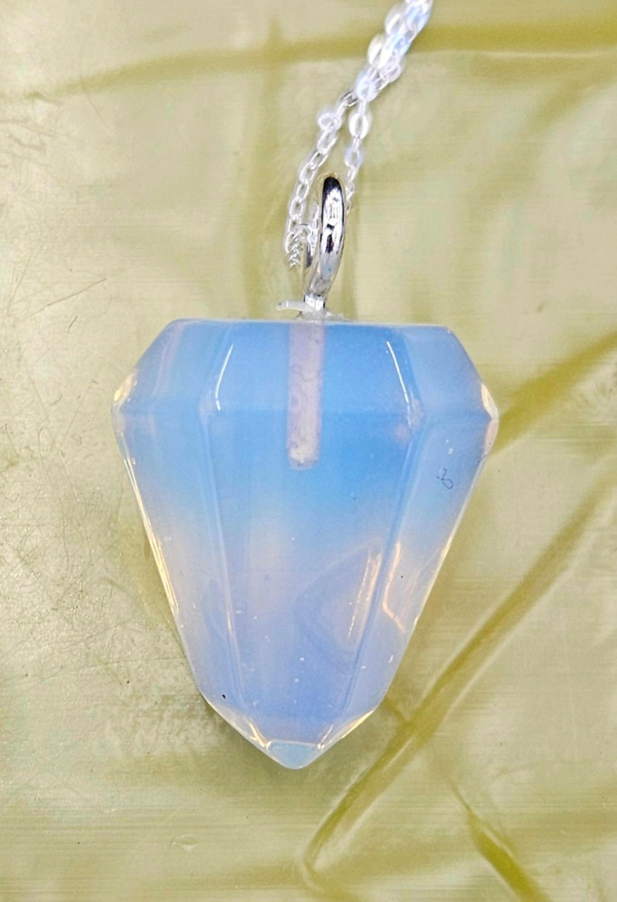 Opalite pendulum set to be worn as a necklace, so it's always handy, with a sterling silver chain on light background.