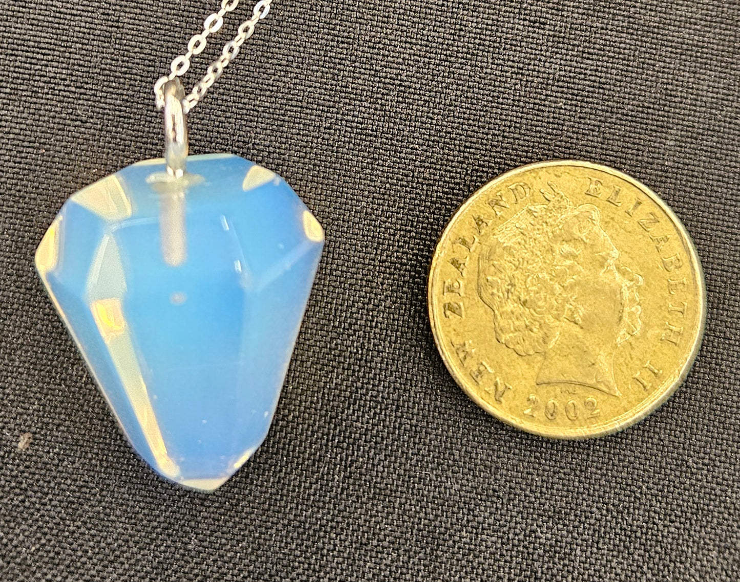 Opalite pendulum set to be worn as a necklace, so it's always handy, with a sterling silver chain with NZ one dollar coin for size comparison.