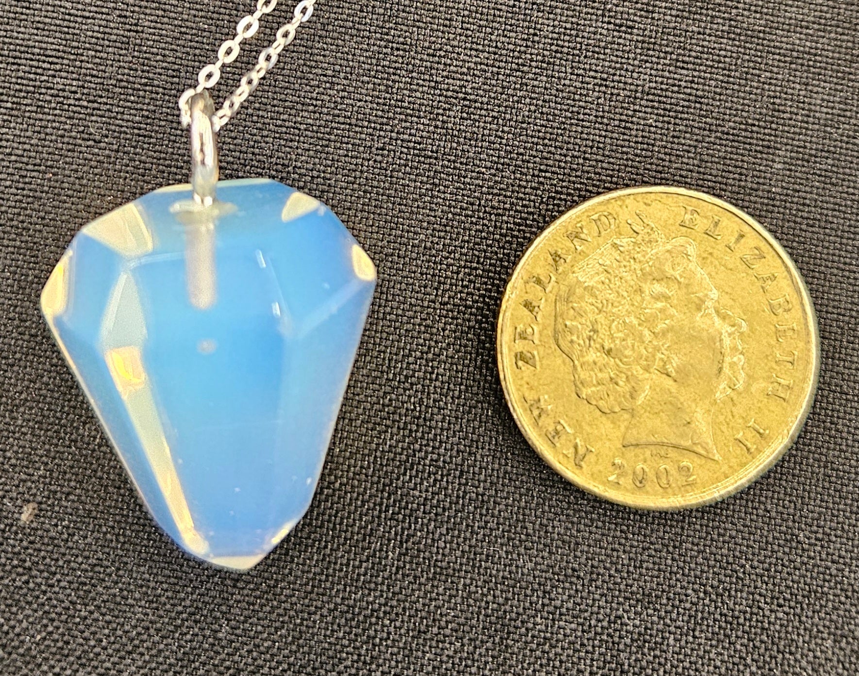 Opalite pendulum set to be worn as a necklace, so it's always handy, with a sterling silver chain with NZ one dollar coin for size comparison.