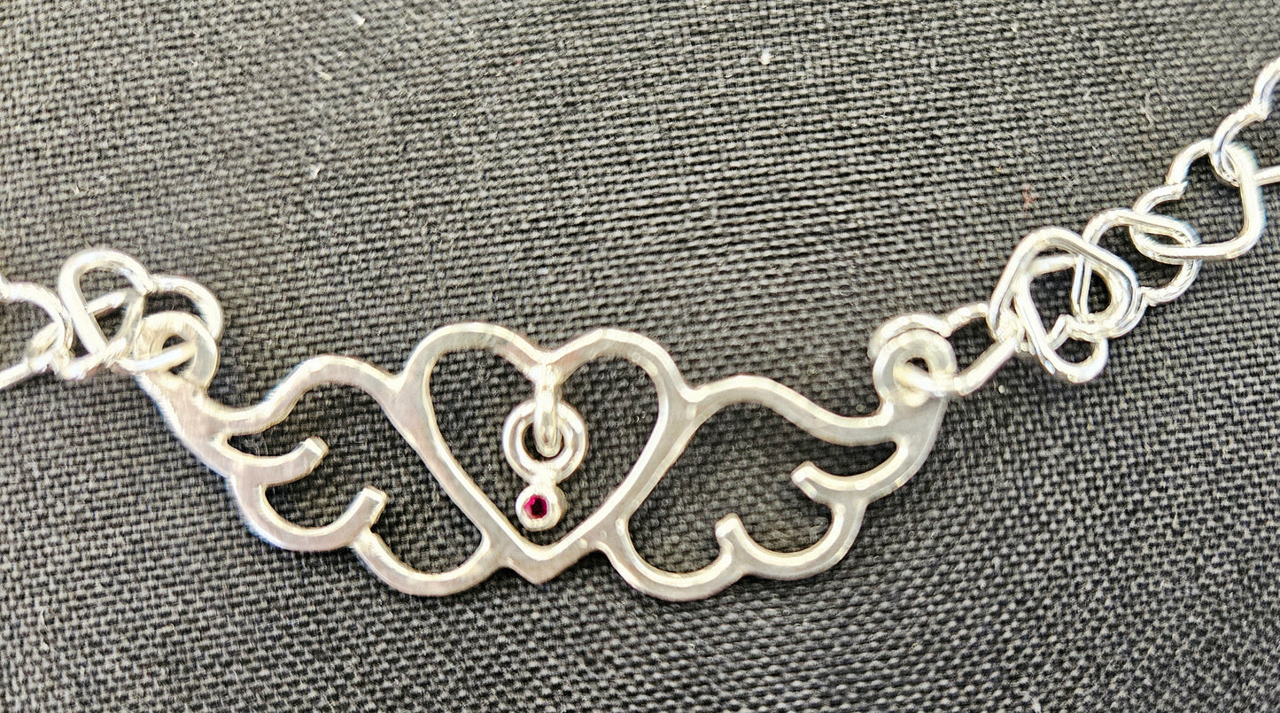 Small (40mm wide) Heart-Wing pendant with a ruby charm, all in solid sterling silver and a solid sterling silver heart chain, closeup of Heart-Wing.