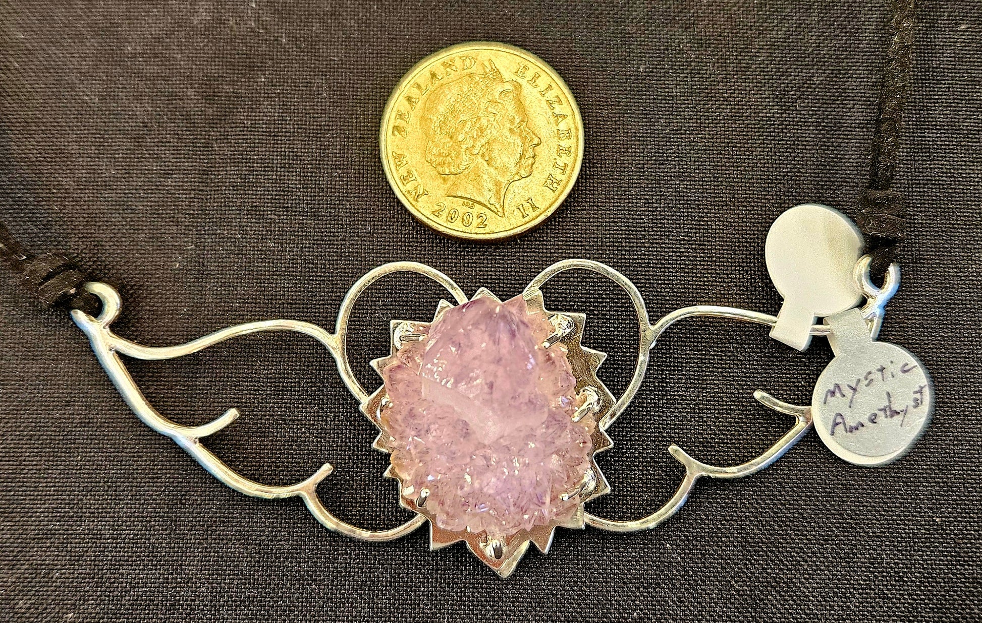Large (100mm) sterling silver Heart-Wings choker-Necklace with Mystic Amethyst and leather chord with NZ one dollar coin for size comparison.