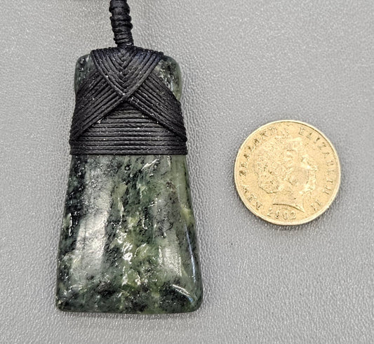 Kawakawa New Zealand Pounamu Toki, medium size, hand made with hand braided chord and NZ Pounamu toggle with NZ one dollar coin for size comparison.