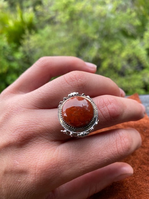 Hand cut New Zealand red jasper from the Hihi stream in the Kauranga valley set in silver plated adjustable ring, suitable for men or women. This is a brilliant red stone with tiny veins of blue chalcedony that bring the stone alive