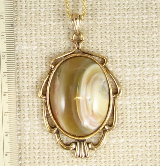 Necklace with a deep purple rhyolite that I collected from the Broken Hills region of the Coromandel Peninsula in New Zealand and hand polished into a 40x30mm cabochon, set in silver plated setting with 19 inch chain - on burlap