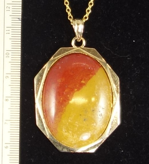 Necklace, bicolour red and yellow jasper from the Hotoritori stream in the Kauranga Valley New Zealand, hand polished into a 40x30mm cabochon and set in a gold plated setting with 19 inch chain
