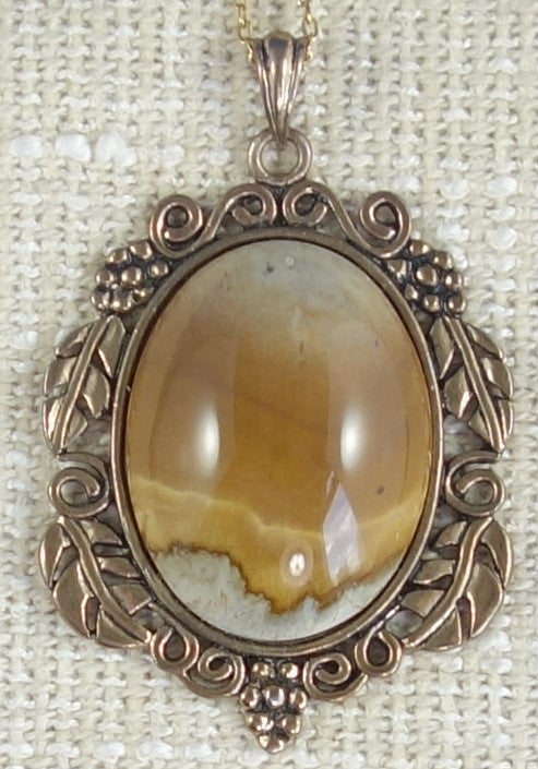 Necklace with Port Albert Concretion that I dug out of the tidal mud and when I cut this stone I found this desert scene inside. This kind of picture figuring is very rare. The stone is hand polished to a 40x30mm cabochon and set in a gold plated setting with 19 inch chain - on burlap