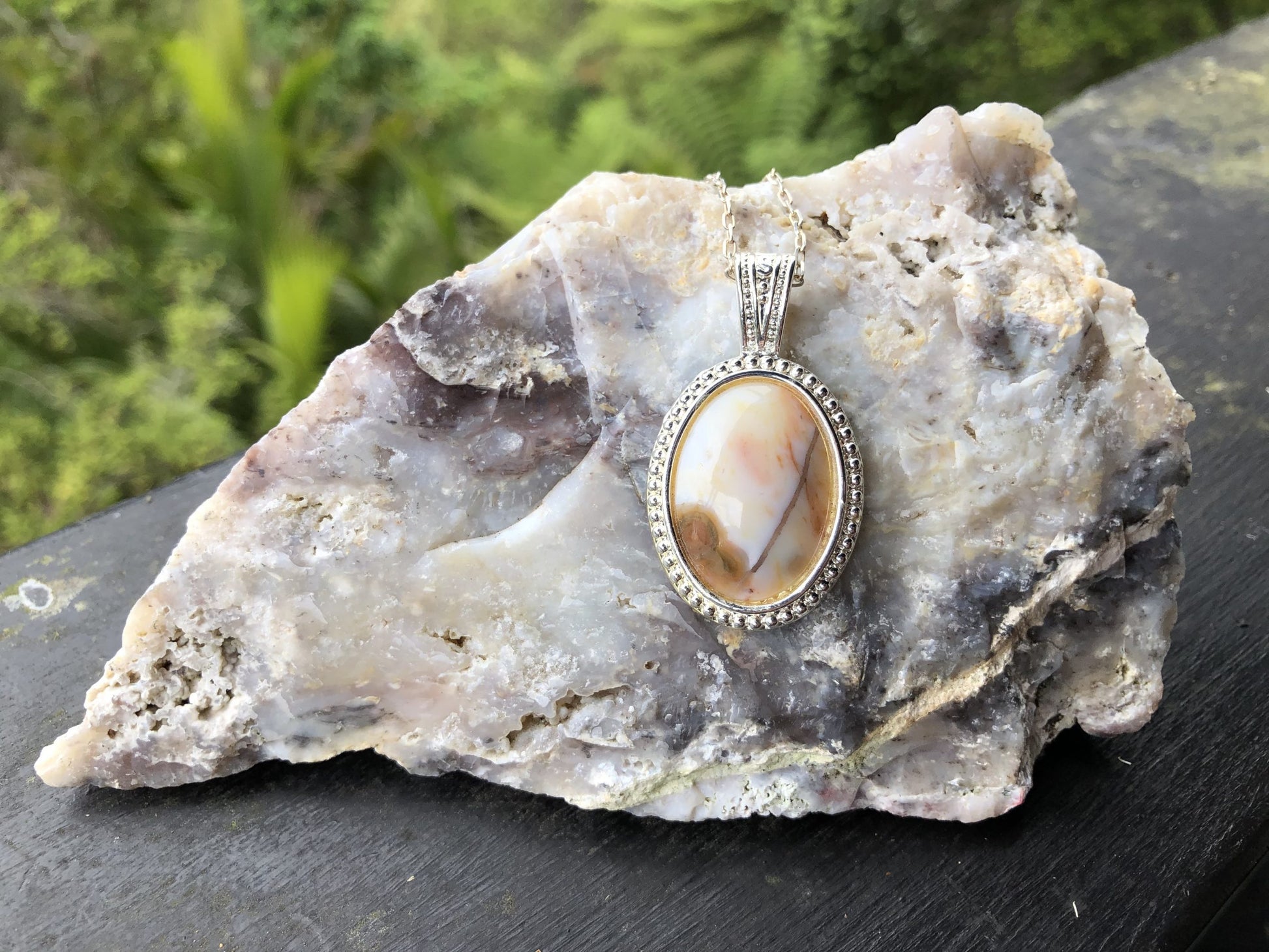 Necklace with Ocean Jasper from Madegascar, white with red and brown patterns, hand polished to a 25x18mm cabochon and set in a silver plated setting with 19 inch chain on Cinebar