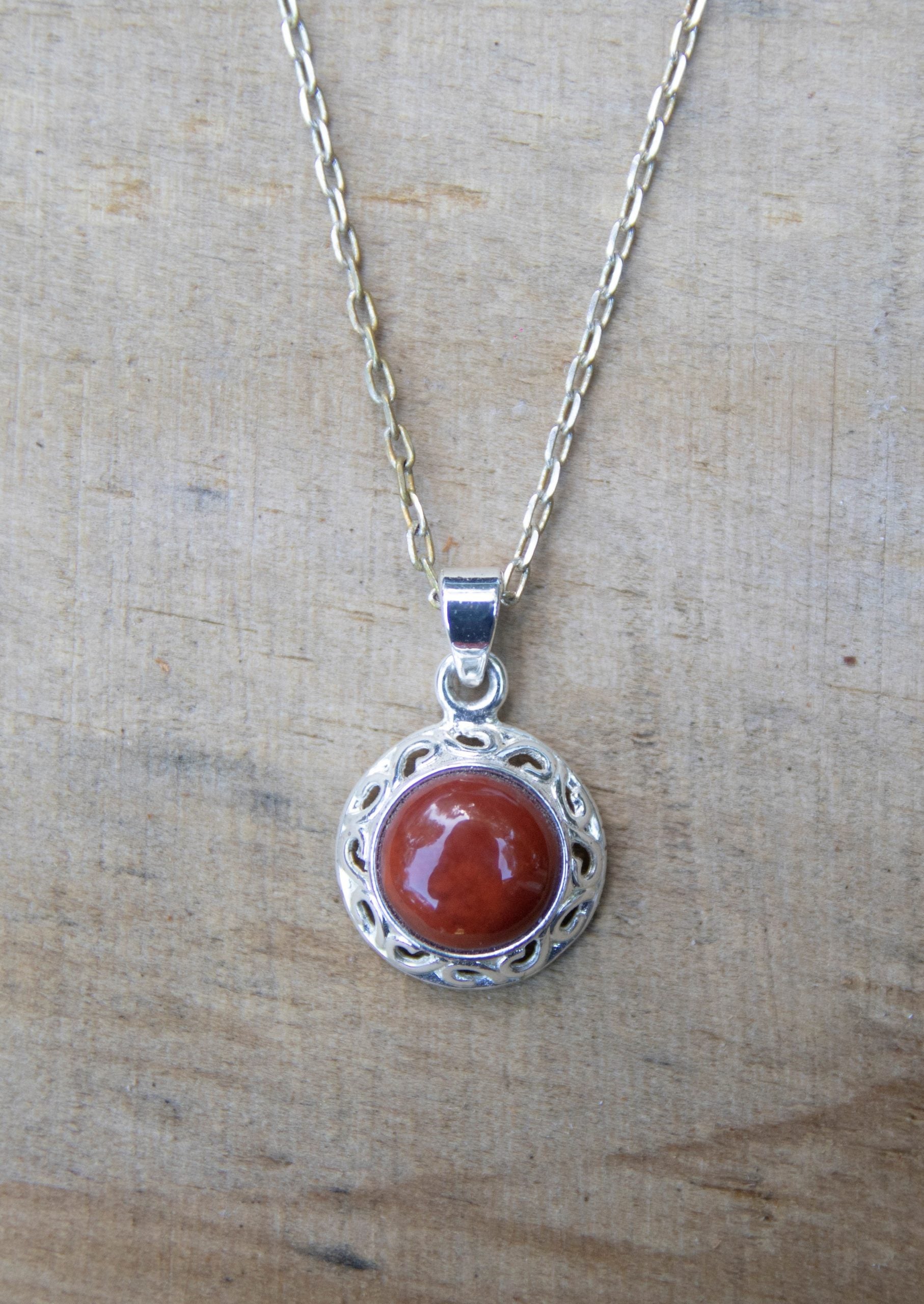 Necklace with New Zealand red Jasper, pure brilliant red, hand polished to a 10mm round cabochon and set in a silver plated setting with 19 inch chain.