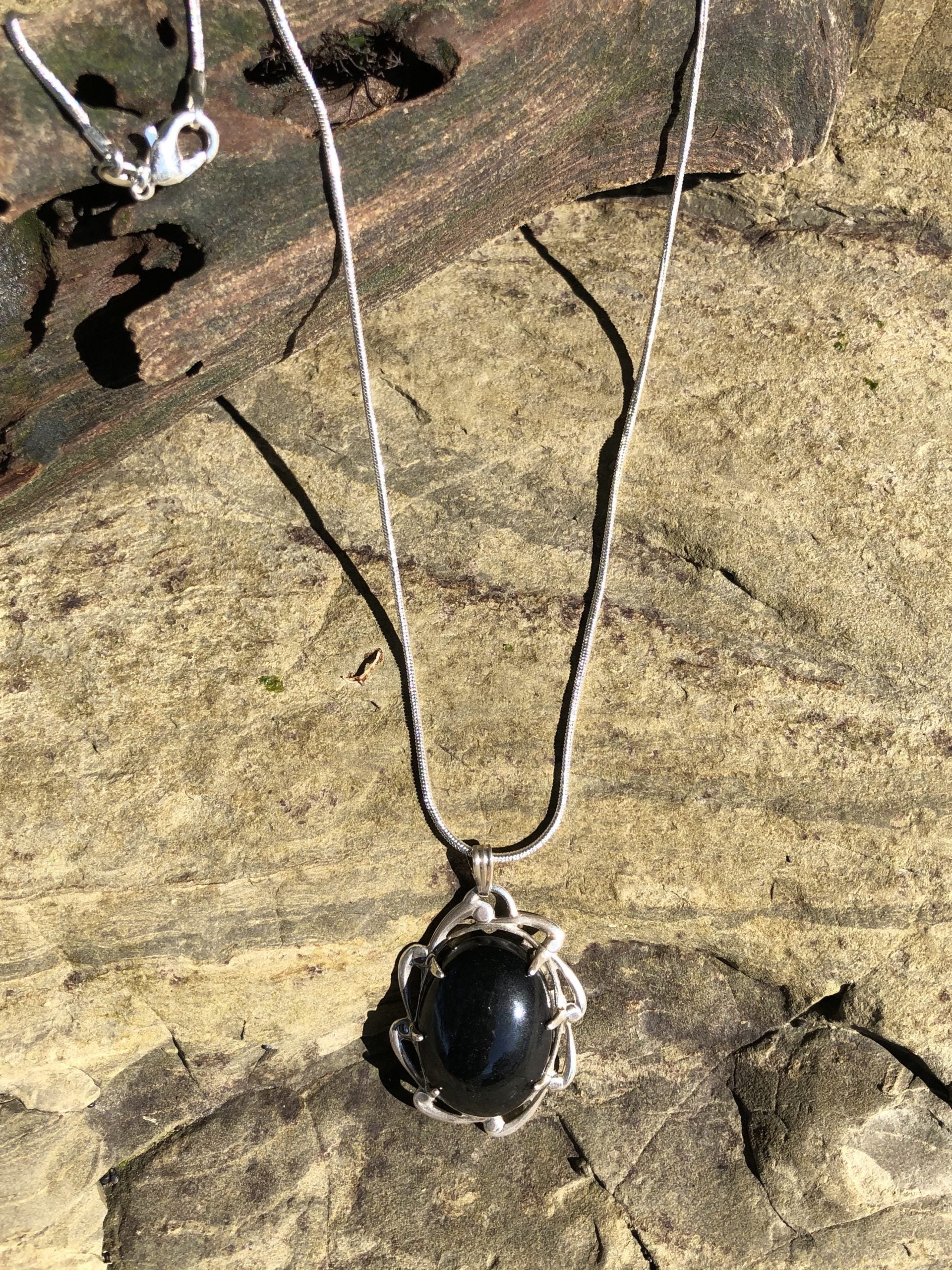 Necklace with New Zealand Kaeo obsidian, pure glistening black, hand polished to a 25x18mm oval cabochon and set in a sterling silver setting with 24 inch sterling silver chain on stone