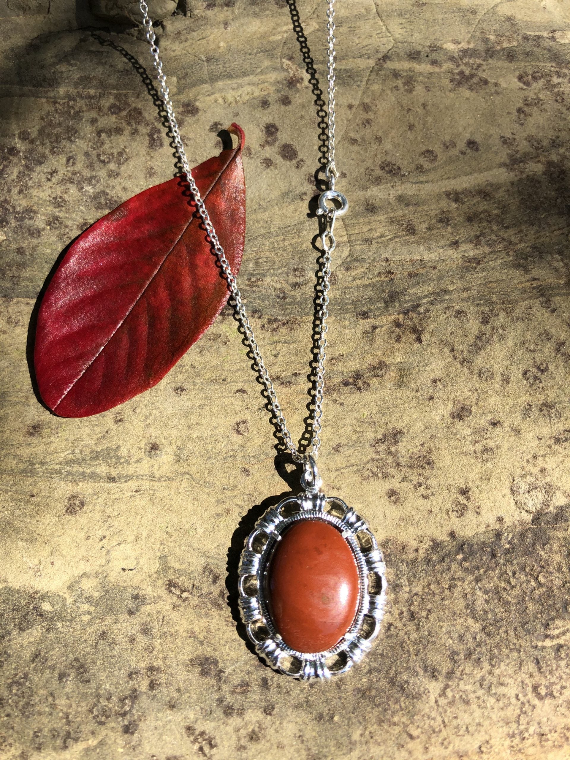 Necklace with New Zealand red Jasper, rich, deep red, hand polished to a 20x15mm cabochon and set in a silver plated setting with 19 inch chain, regular