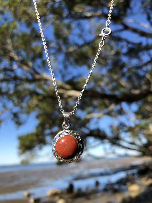 Necklace with New Zealand red Jasper, rich, deep red with tiny flecks of colour variation, hand polished to a 10mm round cabochon and set in a silver plated setting with 19 inch chain.