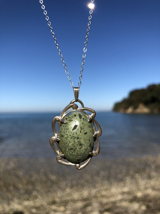 Necklace, green rhyolite from Coromandel NZ, hand polished into a 25x18mm cabochon and set in a sterling silver setting with an 18 inch sterling silver chain
