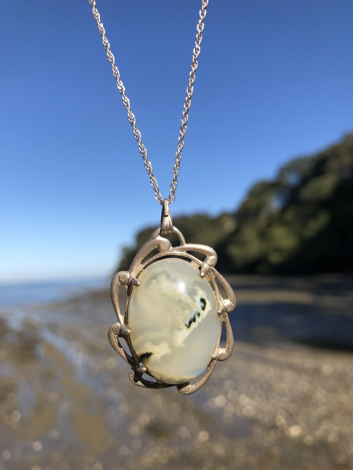 Necklace of Barossa Mountain New Zealand moss agate with green moss on white background, hand cut into 25x18mm cabochon and set in a Sterling silver setting with 20 inch Sterling silver chain