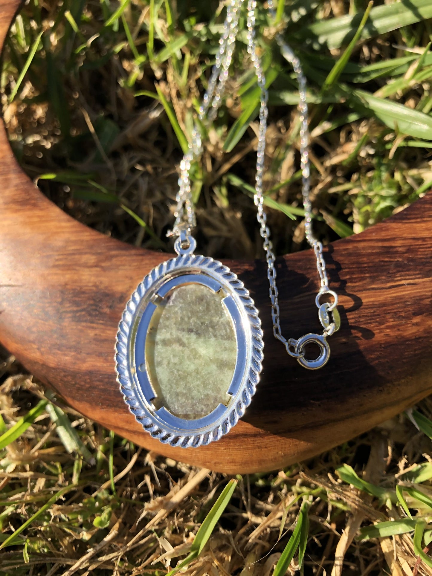 Necklace with an earthy green New Zealand Pounamu (nephrite jade), hand polished to a 25x18mm cabochon and set in a silver-plated setting with a 19 inch chain, back