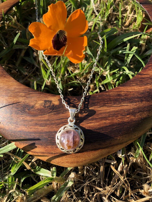 Necklace with natural Super-7, a purple amethyst with golden needles of cacoxenite, hand polished to a 10mm round cabochon and set in silver-plated setting with 19 inch chain, front