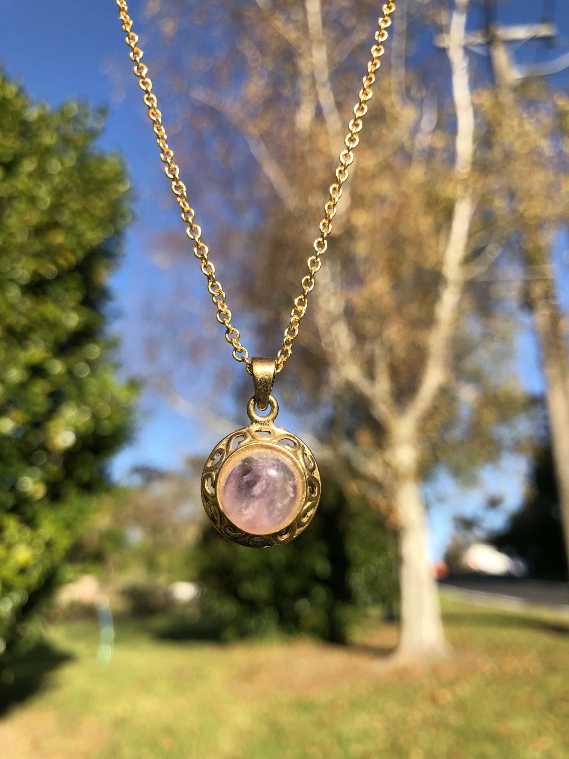 Necklace with natural Amethyst, delicate purple, hand cut to a 10mm round cabochon and set in a gold plated setting with 19 inch chain, in trees