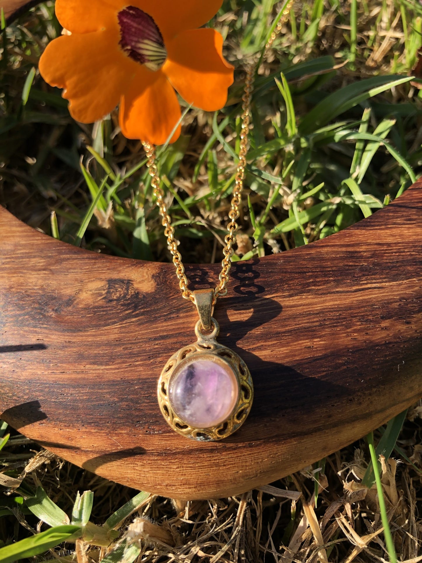 Necklace with natural Amethyst, delicate purple, hand cut to a 10mm round cabochon and set in a gold plated setting with 19 inch chain, ln wood