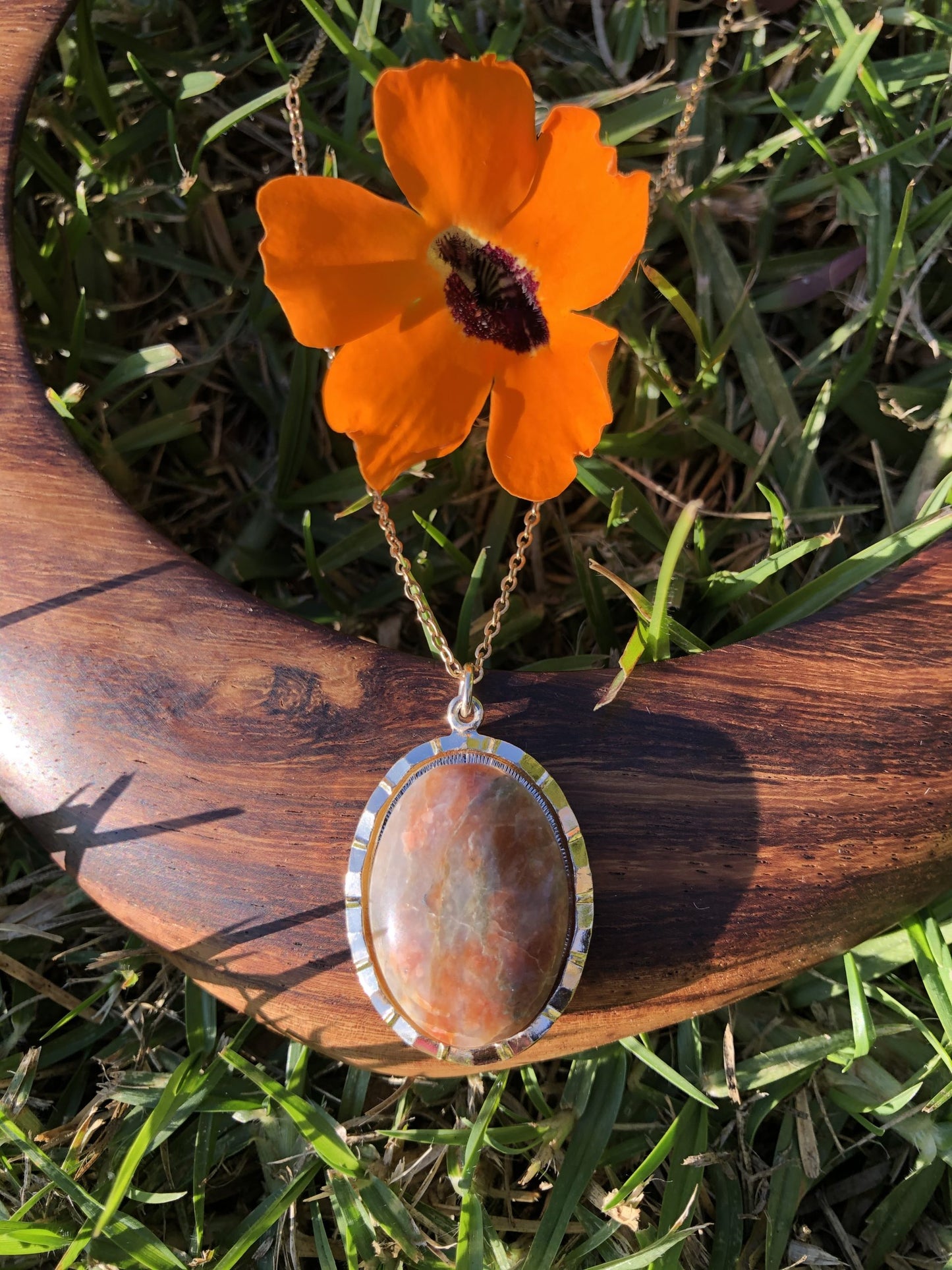 Necklace with lovely Jasper from Scotland, Subtle pink and grey tones, hand polished to a 25x18mm cabochon and set in a gold-plated setting with 19 inch chain on wood
