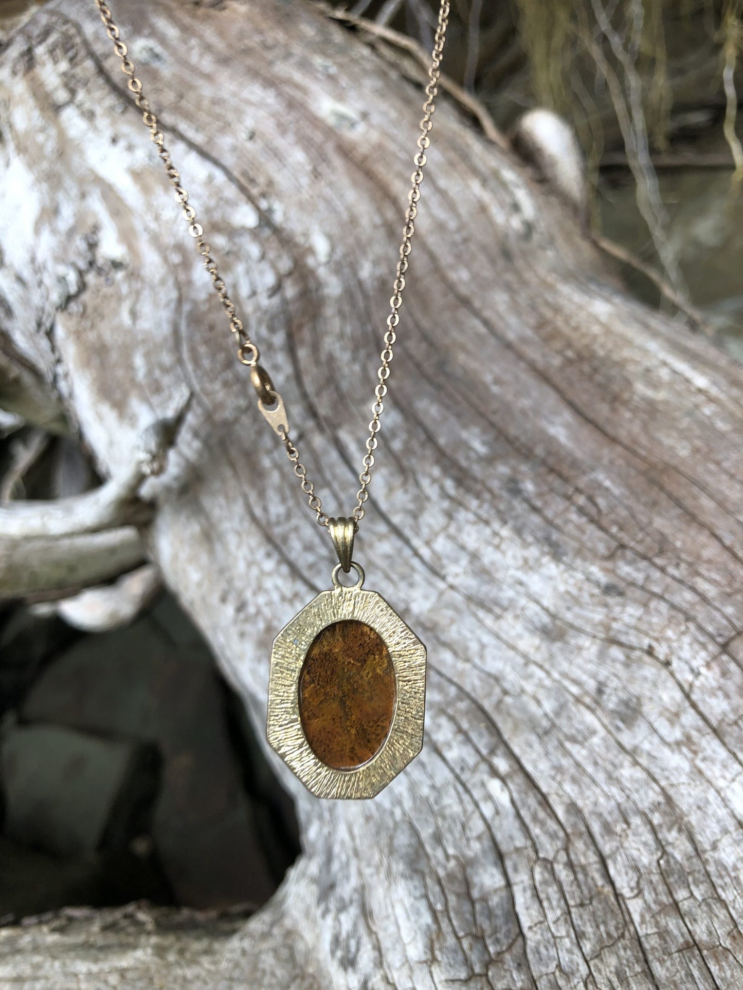 Necklace with New Zealand natural Chakra Jasper, luscious red with patterns of every color of the chakras, yellow, blue, black, orange, white patterns throughout, hand polished to a 25x18mm cabochon and set in a gold-plated setting with 19 inch chain, back