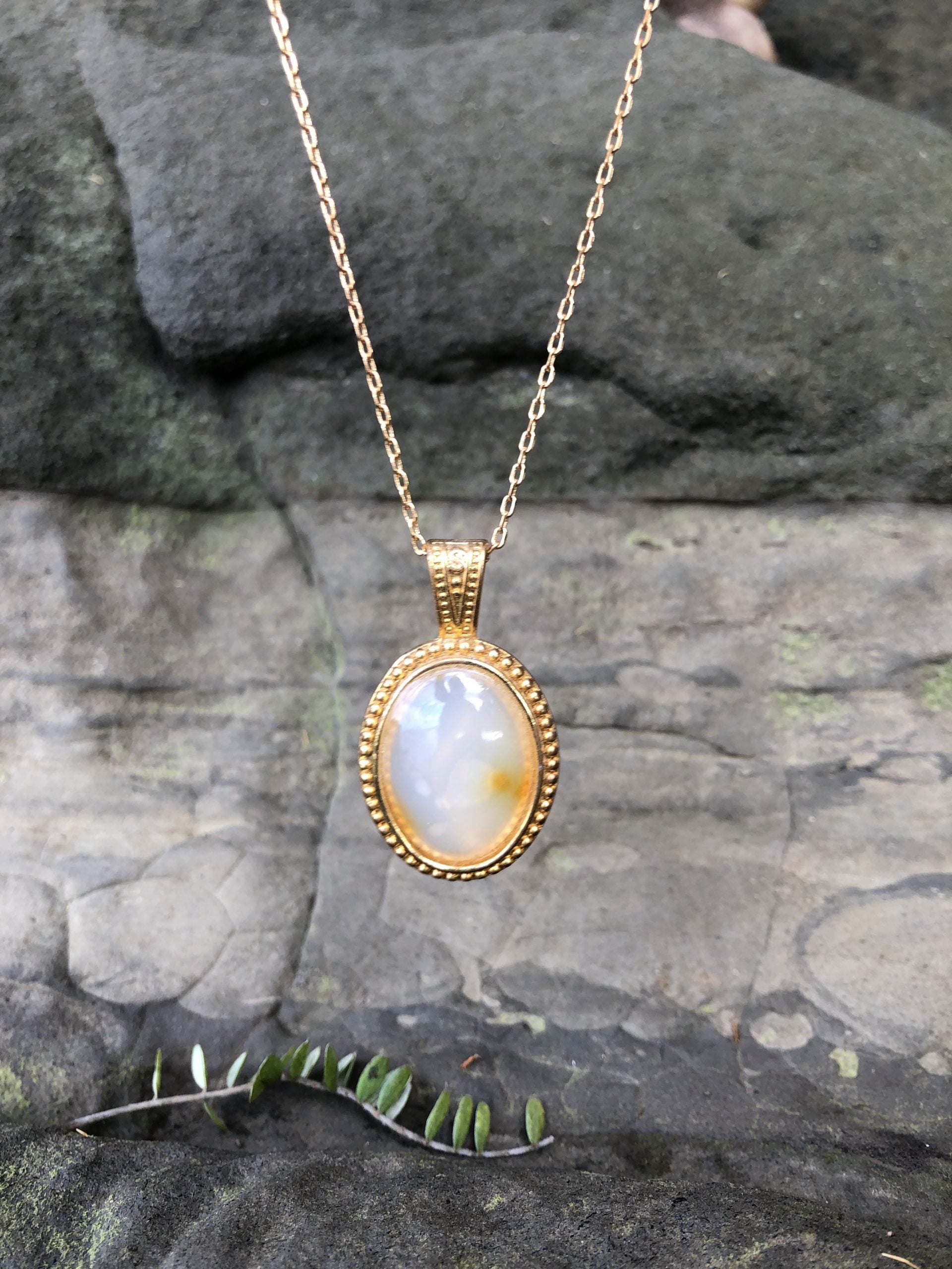 Necklace with a pale yellow with hints of orange New Zealand Carnelian, hand polished to a 25x18mm cabochon and set in a gold-plated setting with 19 inch chain, other