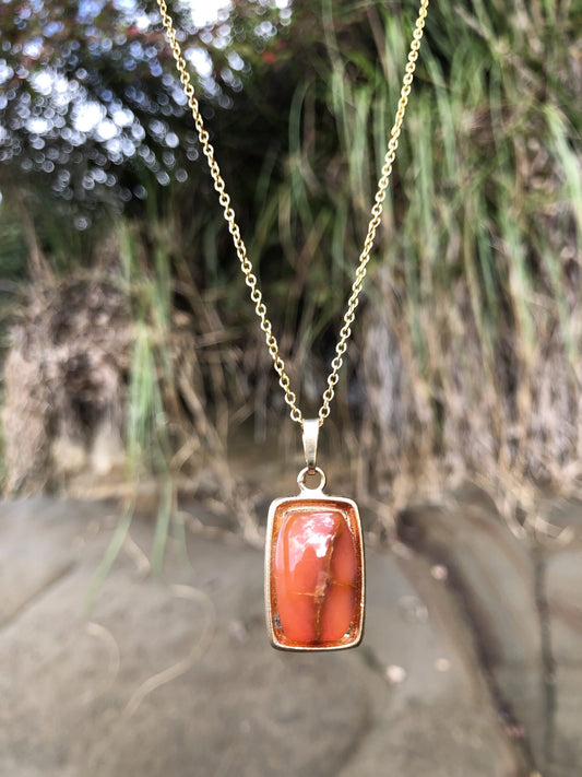 Necklace with a bright orange New Zealand Carnelian, hand polished to a 18x13mm rectangle and set in a gold plated setting with 19 inch chain.