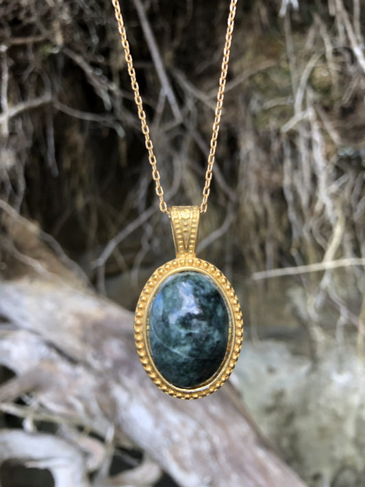 Necklace with natural New Zealand serpentine, dark green with subtle markings, hand polished to a 25x18mm cabochon and set in a gold-plated setting with 19 inch chain on driftwood
