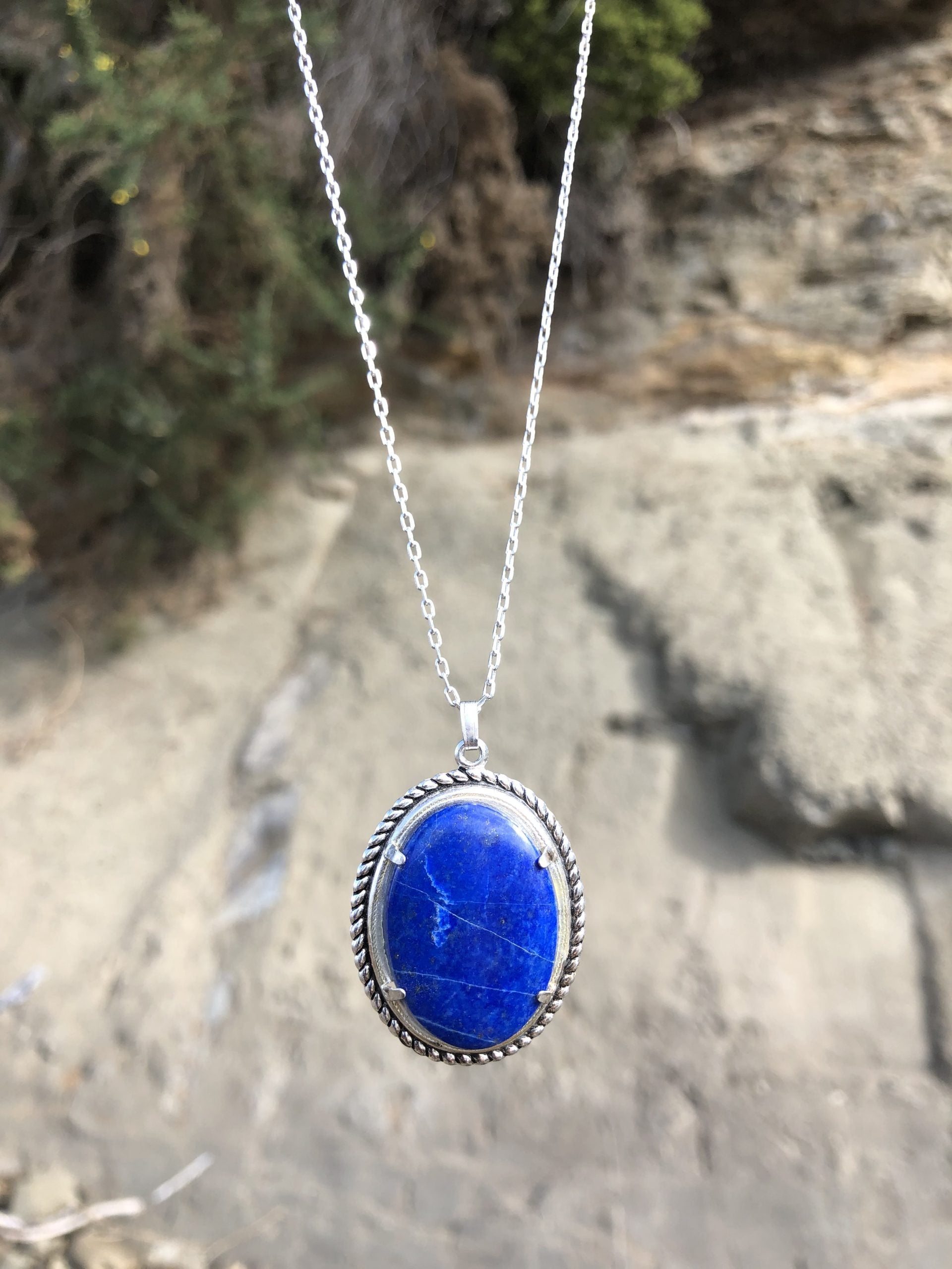 Necklace with rich blue lapis lazuli, hand cut to a 30x20mm cabochon and set in silver plated setting with 19 inch chain