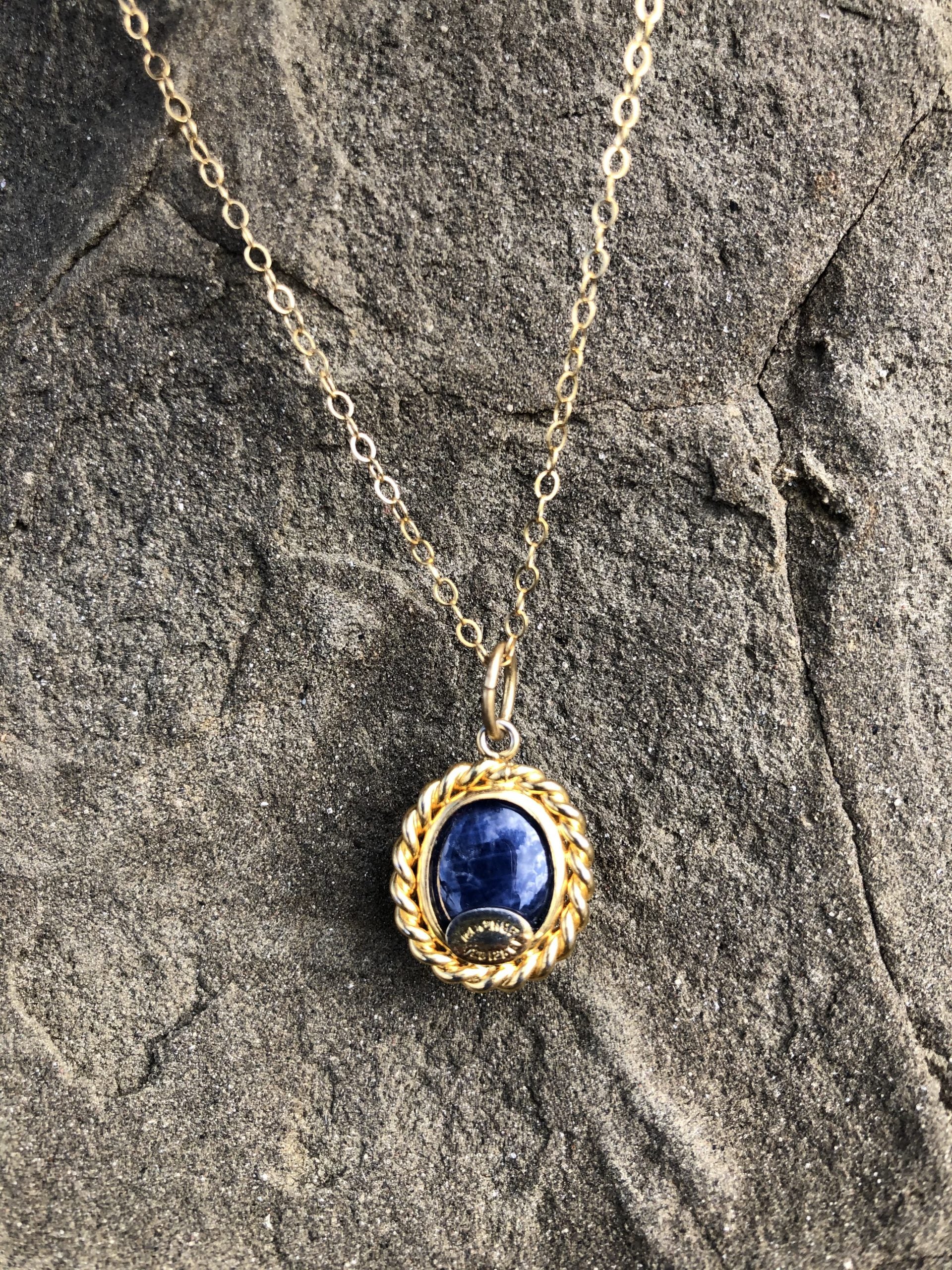 Necklace with a rich blue sapphire, hand polished to a 12x9mm cabochon and set in 14 carat gold filled setting with an 18 inch, 14 carat gold filled chain, back