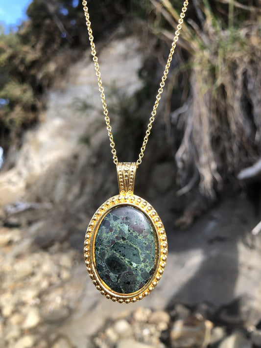 Necklace, green brecciated rhyolite from Coromandel NZ, hand polished into a 30x20mm cabochon and set in gold plated setting with 19 inch chain