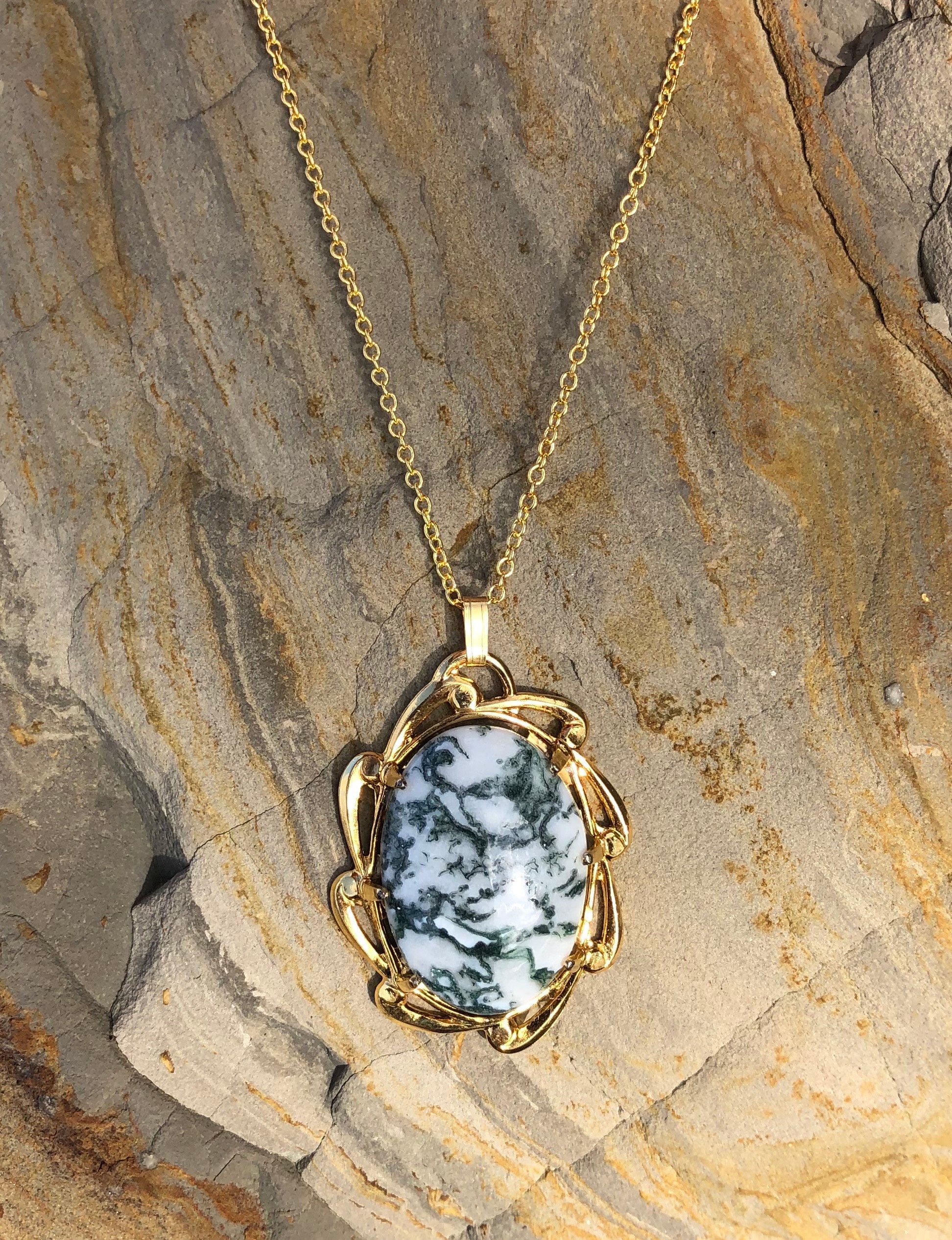 Necklace with natural Tree Agate, a unique type of moss agate with a white background behind fine green "moss". The stone is hand polished to a 25x18mm cabochon and set in a gold plated setting with 19 inch chain, on stone