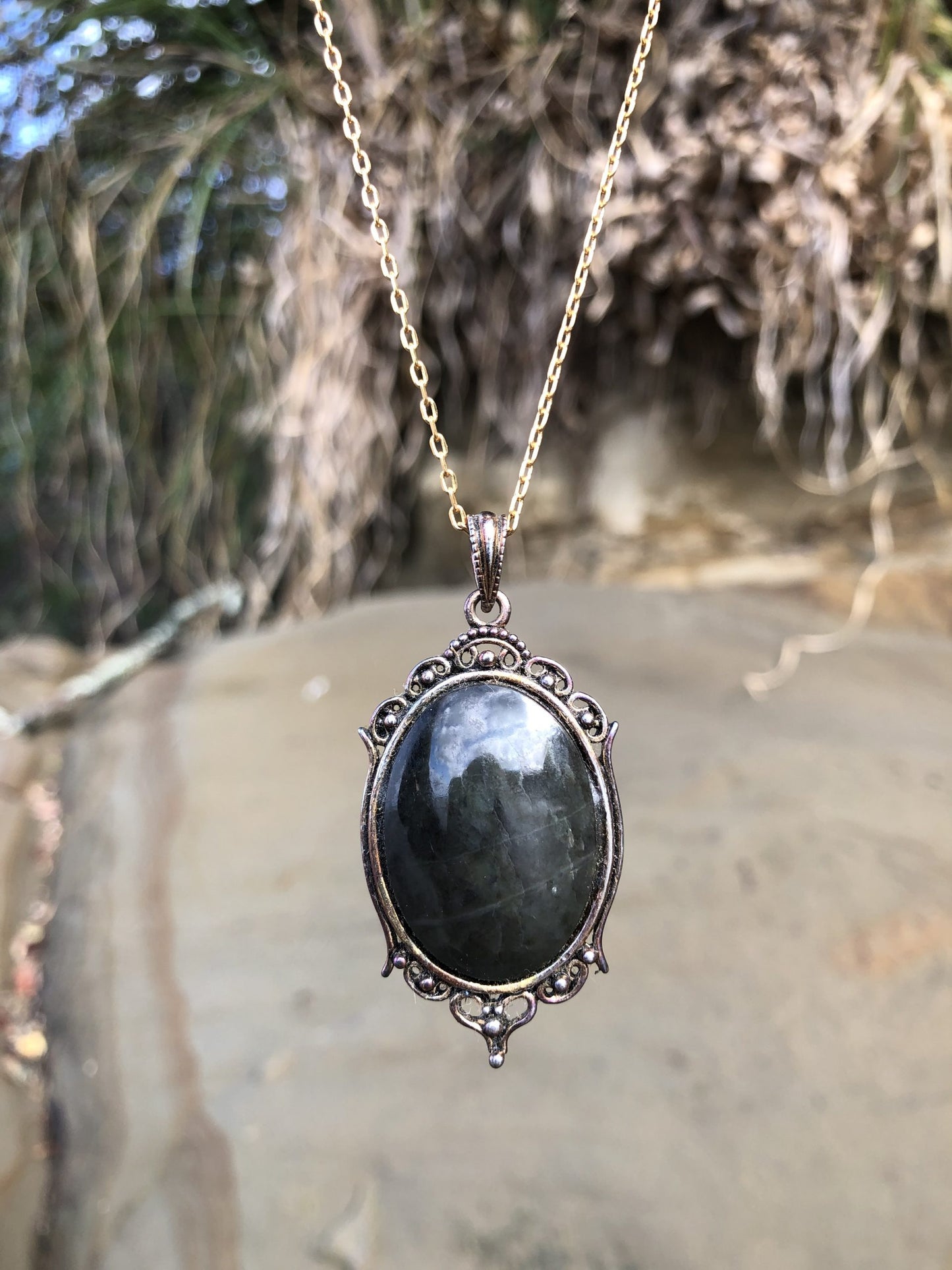 Necklace with rare New Zealand Black Jade (greenstone or Pounamu), hand polished to a 30x22mm cabochon and set in a copper tone setting with 19 inch chain.