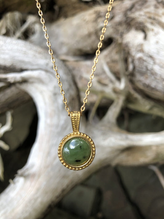 Necklace with natural Russian Nephrite Jade, bright green with black spots, hand polished to a 12mm round cabochon and set in a gold plated setting with 19 inch chain, front